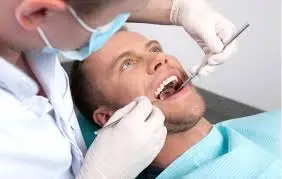 Professional dentist at Family Dental Clinic Noida performing periodontal examination on patient